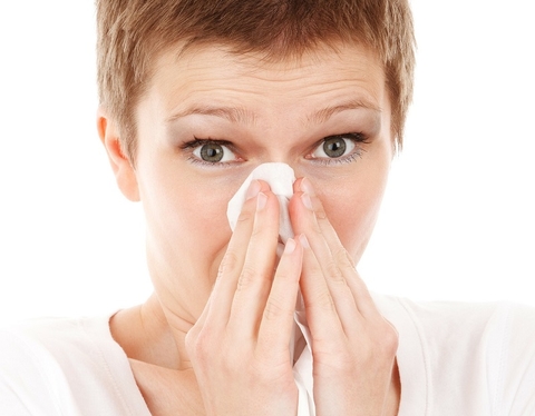 Woman blowing nose Woman blowing nose