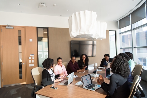 Diverse boardroom Diverse group of women sitting around table