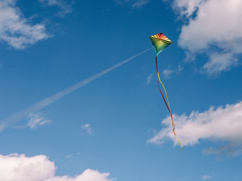 kite multicolored kite against the blue sky