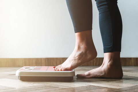 Weight loss scale A person stepping onto a scale