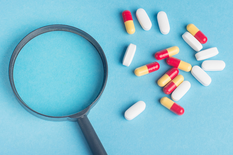 Magnifying glass and pills photo Magnifying glass and pills photo
