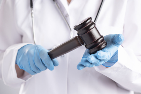Doctor with gavel A doctor holds a gavel