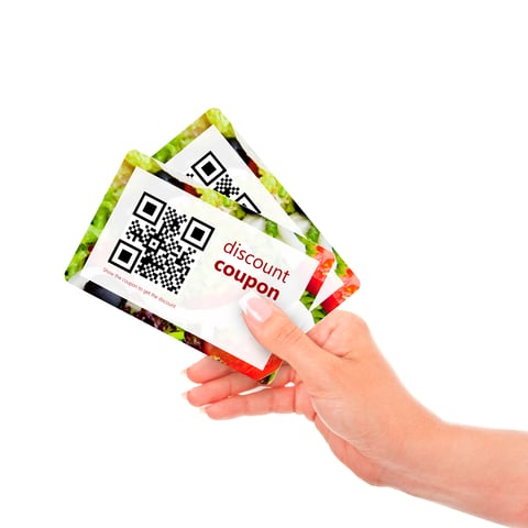 Coupons (CREDIT: Getty/ayo888) Hand holding two coupons