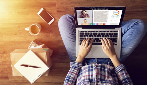 Telework work from home A woman working remotely with her laptop on her lap