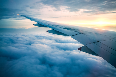 TIp of aircraft wing inflight with blue sky and clouds TIp of aircraft wing inflight with blue sky and clouds