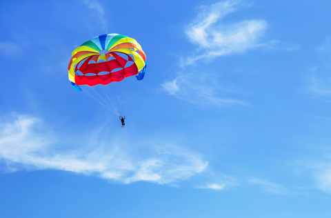 Parachute jumping. Parachute is in the sky, under the clouds. Parachute