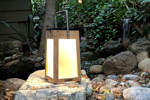 Tinka Made in a warm teak finish, this outdoor lantern features clean lines, a pivoting handle and a slightly tapered base for balance.