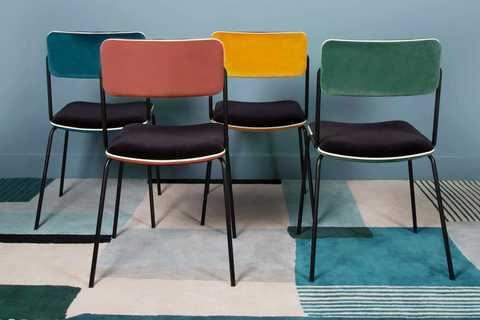 Double Jeu chair Bearing clean lines, the Double Jeu chair has a steel frame and uses black Italian velvet and white piping.
