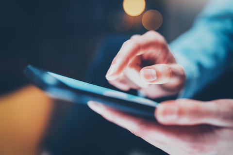 Person using app on mobile device Holding smartphone and using app