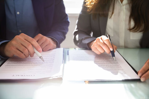 Lawyers reviewing contract Lawyers reviewing paperwork