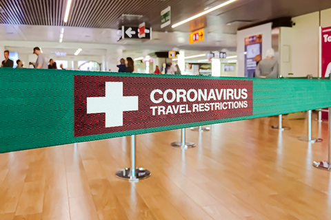 Coronavirus travel restrictions sign at airport Coronavirus travel restrictions sign at airport