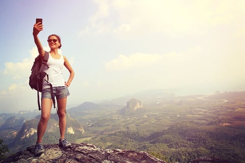 female hiker taking a selfie // Photo by lzf/iStock/Getty Images Plus/Getty Images female hiker taking a selfie