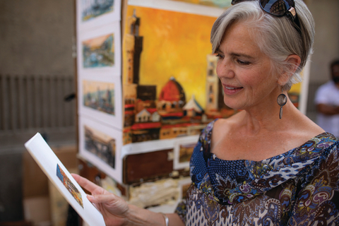 Go Local Artwork Tour Image of woman holding artwork