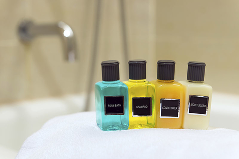 Hotel Toiletries - Kenishirotie/iStock/Getty Imges Plus/Getty Images Hotel Toiletries on a white towel