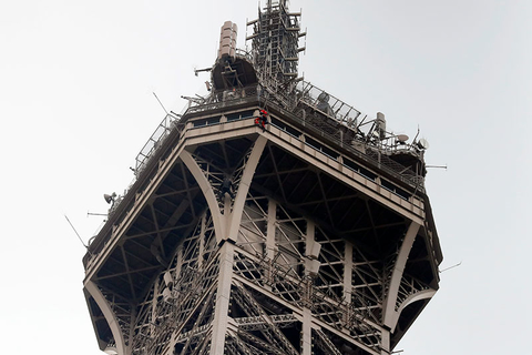 Man Climbing Eiffel Tower Newscred Editorial Travel Group Only A rescue worker hangs from the Eiffel Tower.