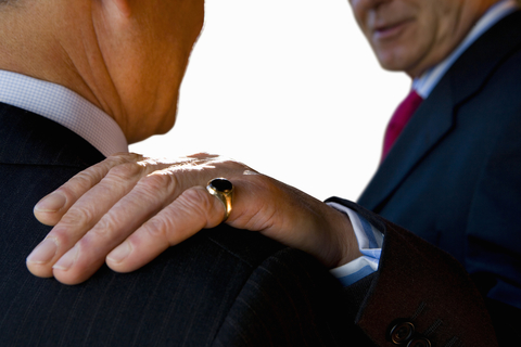 Emotional intelligence business man with hand on shoulder