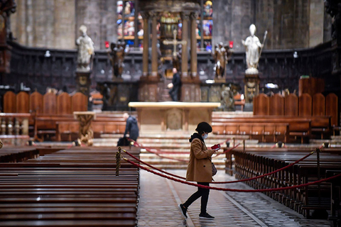 Coronavirus Italy Newscred Editorial Do Not Reuse A tourist wearing a face mask walks inside the Duomo gothic cathedral as it reopened to the public after being closed due to the COVID-19 virus outbreak in northern Italy, in Milan, Monday, March 2.