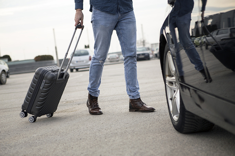 man with luggage walking to rental car man with luggage walking to rental car
