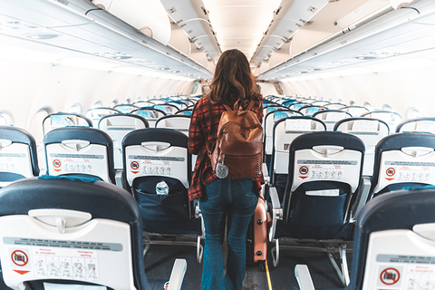 woman walking down plane aisle woman walking down plane aisle