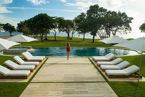 woman at a villa pool - Island Destinations woman at a villa pool