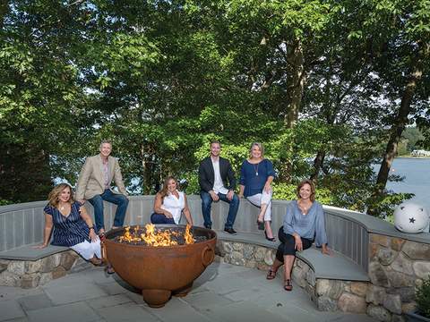 Largay Travel management Lori Bartlett, Paul Largay, Melissa Russo, Scott Largay, Amanda Klimak and Vira Mastroianni pose at Paul Largay’s home on Lake Quassapaug, Middlebury, CT