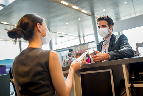people in masks at airport gate people in masks at airport gate