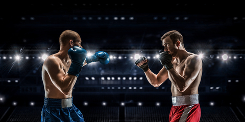 Boxer and MMA fighter facing each other Boxer and MMA fighter in the ring
