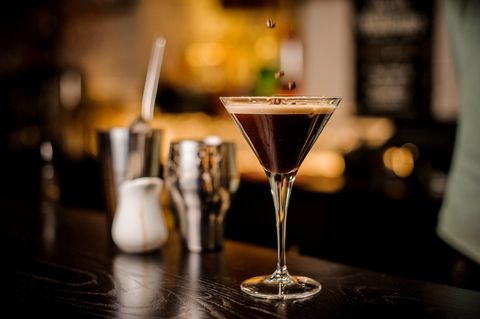 Espresso Martini on a bar garnished with coffee beans Espresso Martini on a bar