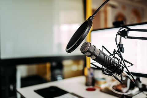 Podcast Getty Close-up image of microphone in podcast studio.