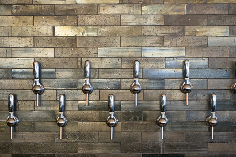Taps set into wall Silver taps on modern bar wall