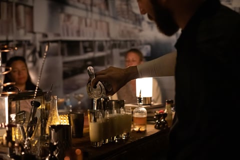 Bartender pouring drinks at The Butchershop inside Irvine Marriott
