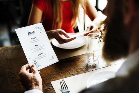 Couple reading menu in restaurant Couple at a restaurant reading the menu