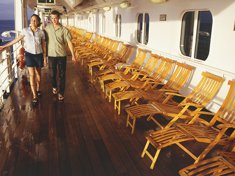 Young Couple Walking on Cruise Ship Deck Getty Young Couple Walking on Cruise Ship Deck