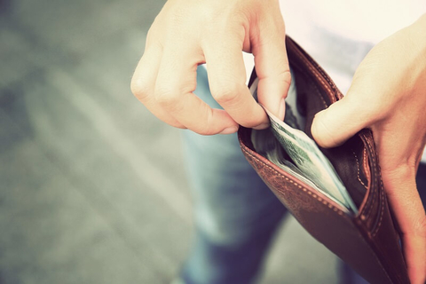 Finance money cash patient consumer payment deductible copay collections (Getty/lzf) A man taking cash out of his wallet