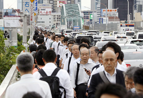 Osaka Earthquake Travel Group Only Editorial Newscred People walk on a bridge while train and subway service were suspended to check for damage after an earthquake in Osaka, western Japan.