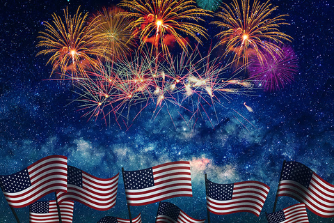 Fourth of July Getty American flags with Fourth of July fireworks overhead