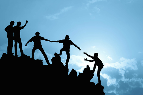 Teamwork on a mountain People using teamwork to climb