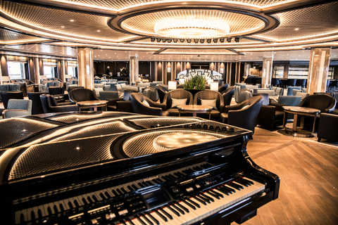 Silver Spirit Dolce Vita Lounge A piano in front of lounge seating at the Dolce Vita Lounge