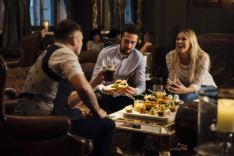 Millennial dining trends three people sitting around a table eating