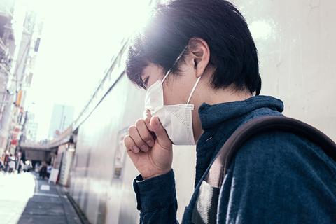 Japanese man coughing with mask on Japanese man coughing with mask on