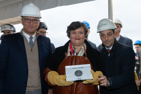 Carnival Panorama Coin Ceremony Officials from Carnival stand together with the coin in the middle