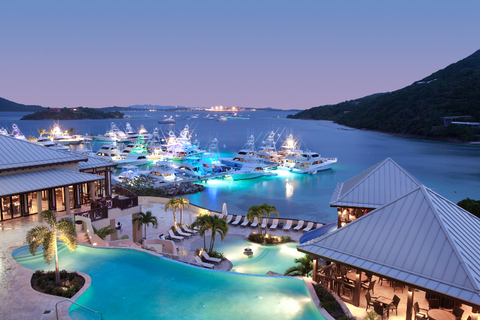 Scrub Island Resort Dusk A view of the tiered infinity pools and marina at dusk