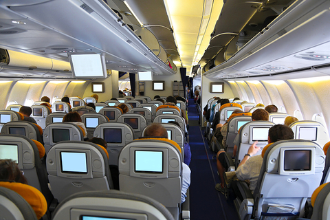 airplane cabin with seat-back entertainment // Photo by egdigital/iStock/Getty Images Plus/Getty Images egdigital/iStock/Getty Images Plus/Getty Images