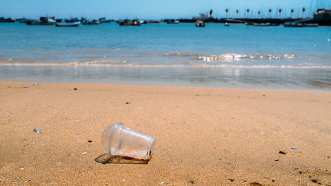 Overtourism Getty Rubbish Plastic cup left on the beach