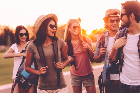 Millennials traveling // Photo by g_stockstudio/iStock/Getty Images Plus/Getty Images Group of young men and women traveling