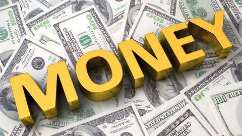 The word money on the background of one hundred dollar bills money on the background of $100 bills