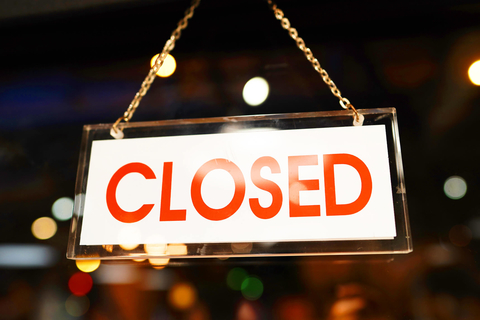 Closed sign in the window of a restaurant Closed sign in the window of a bar