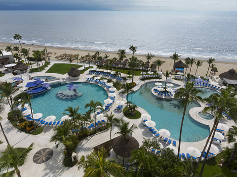 Mexico development with pools, the ocean and palm trees
