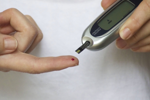 Diabetes test strip Person testing insulin with test strip