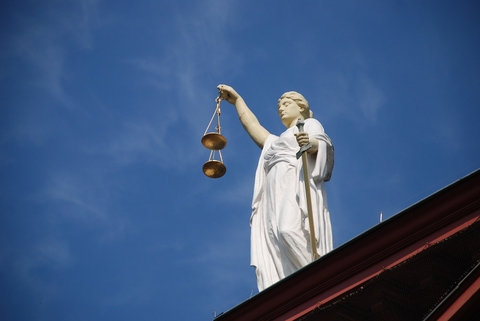 Law Statue holding justice scales